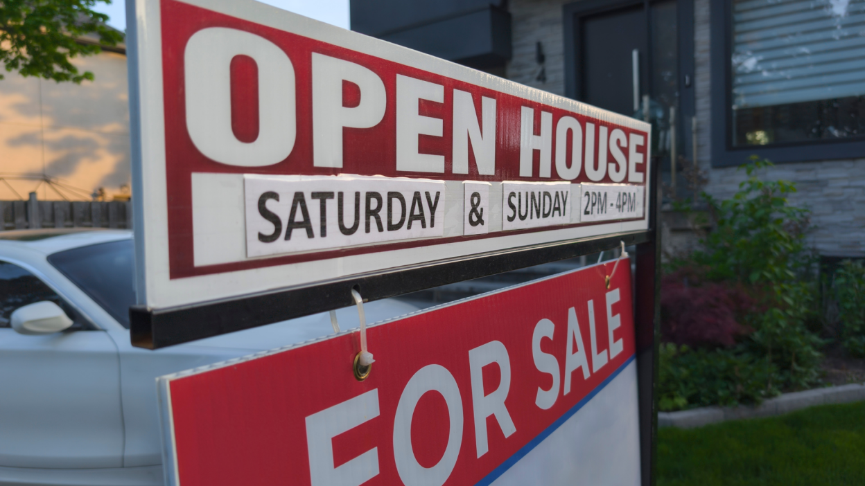 Open House / For Sale sign posted outside a house