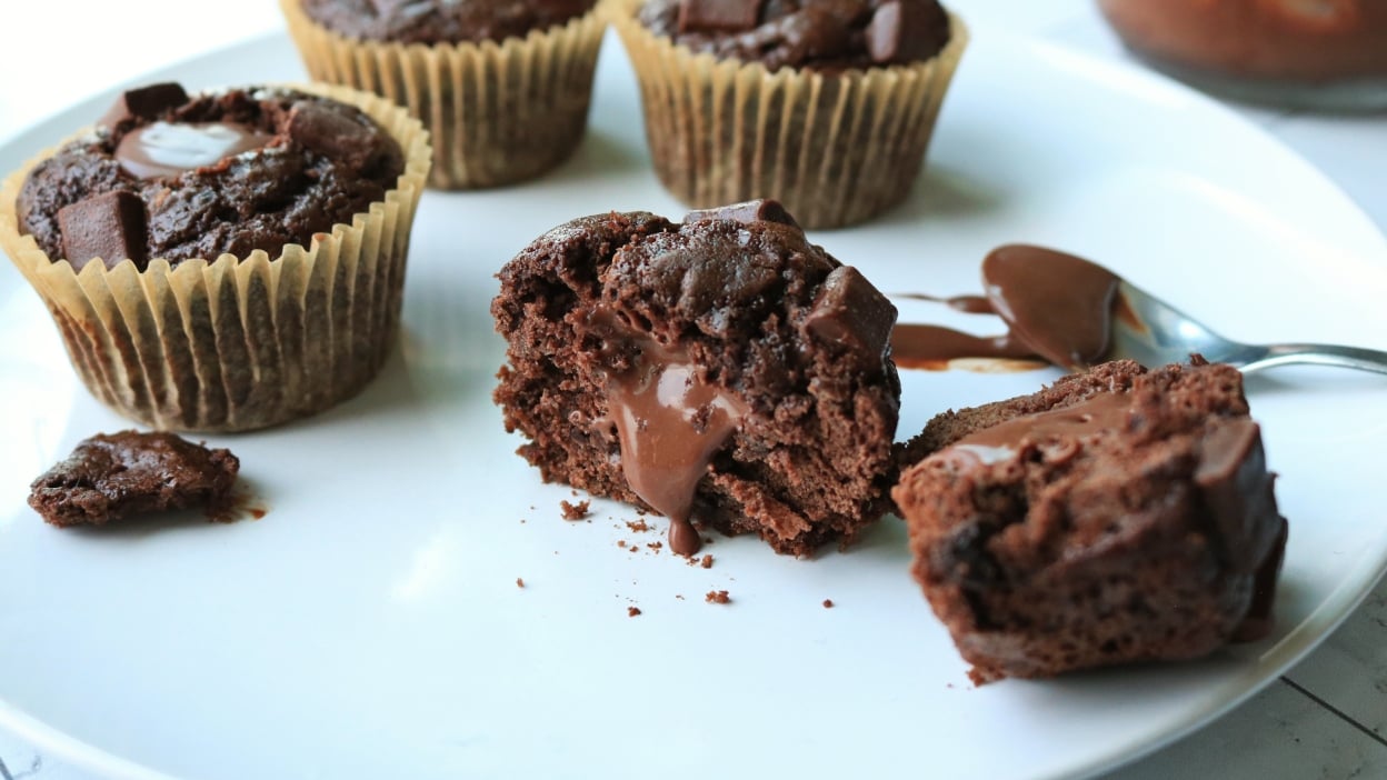 Chocolate muffins on a white plate.