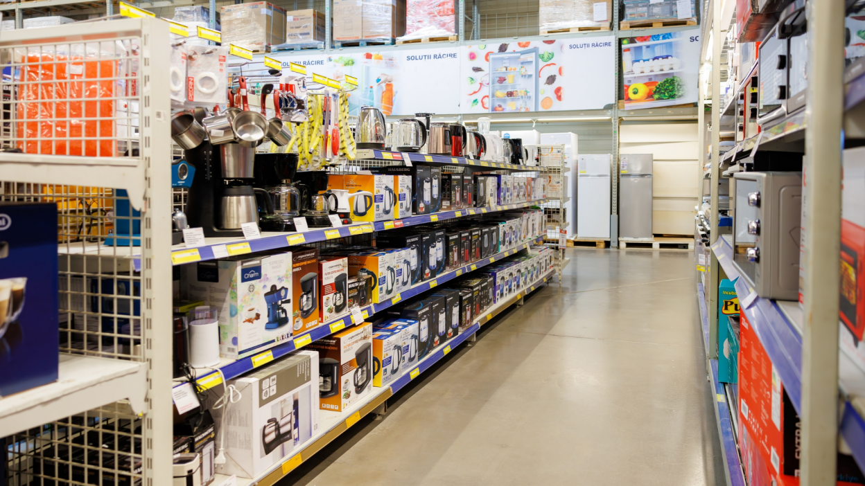 An organized aisle of a large retail store with small home appliances