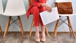 Job applicant sitting with resume in hand