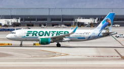 Frontier Airlines Airbus A320 airplane parked on airport runway