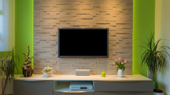 flat screen TV mounted on brick wall