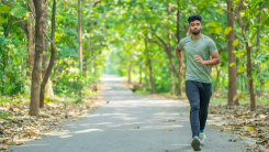 Man jogging, running through the woods