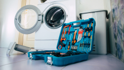 Toolbox in front of open washing machine 