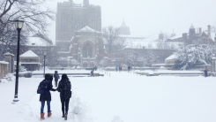 college students walking across a snowy campus