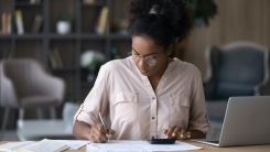 Woman working at desk with laptop 