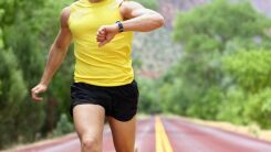 Man running while looking at his watch