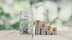 coins in a jar along with "2024" written in blocks