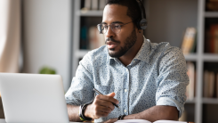 Man focused working on laptop.