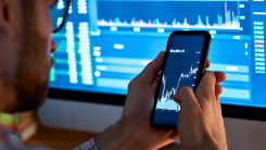 A man checking the value of his bitcoin on a phone