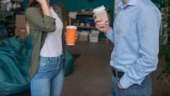 Two people making small talk in a coffee shop