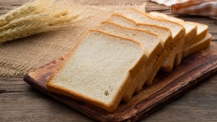 Slices of sandwich bread on a cutting board.