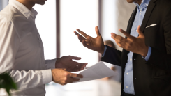 Two people disagreeing in an office setting