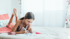 Tween girl drawing in bedroom