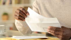 Close up of hands opening envelope