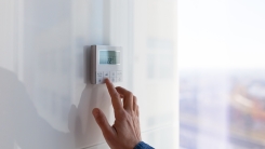 Person adjusting thermostat