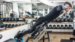 A person doing a back extension exercise at the gym