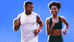 Two runners wearing fitness trackers on a colored background