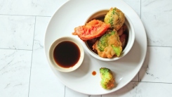 Lightly battered vegetables in a bowl.