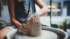 woman making pottery on a pottery wheel