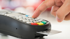 Credit card inserted into chip reader.