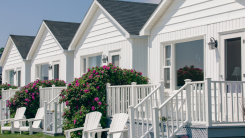 A row of cute white houses with a shared backyard