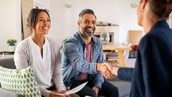 Couple shaking hands with lender.