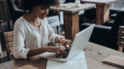 Woman on laptop in cafe 