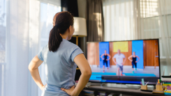 person exercising in front of their TV