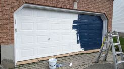 A partially painted garage door