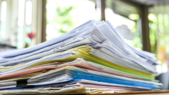 pile of paperwork stacked on a table