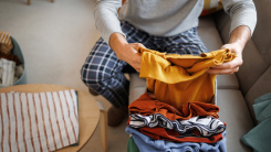 man folding laundry