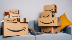 Many different Amazon packages piled on a couch