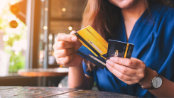 Closeup image of a woman holding and choosing credit card to use