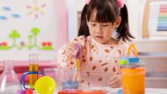 young girl doing science experiment 