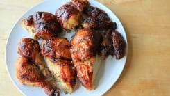 A carved chicken on a white plate.