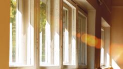 Bright rays of sun streaming through curtainless windows