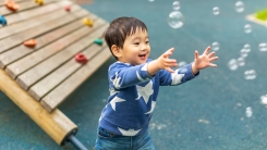 Little boy playing with bubbles