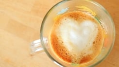 Overhead view of a latte with a heart in the foam.