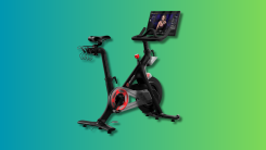 Peloton Indoor Exercise Bike on a teal and green gradient background.