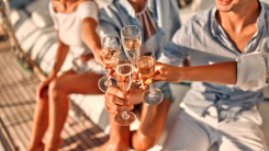 People clinking Champagne glasses on a yacht