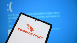 CrowdStrike logo displayed on a phone in front of a Blue Screen of Death