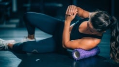 person using a purple foam roller