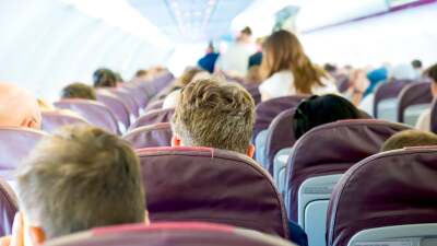 back view of people sitting on an airplane