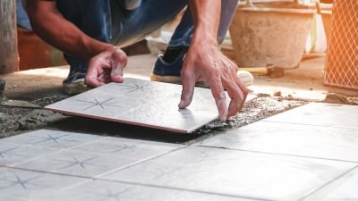 Contractor installing tiles