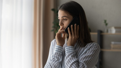 Stressed woman on phone call.