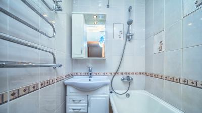 A small white tiled bathroom