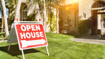 Open house sign in a yard in front of a house