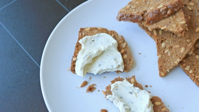 Sunflower seed crackers with cheese spread on them