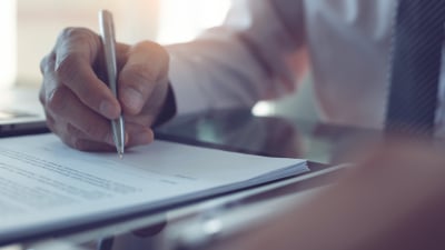 Man signing document 